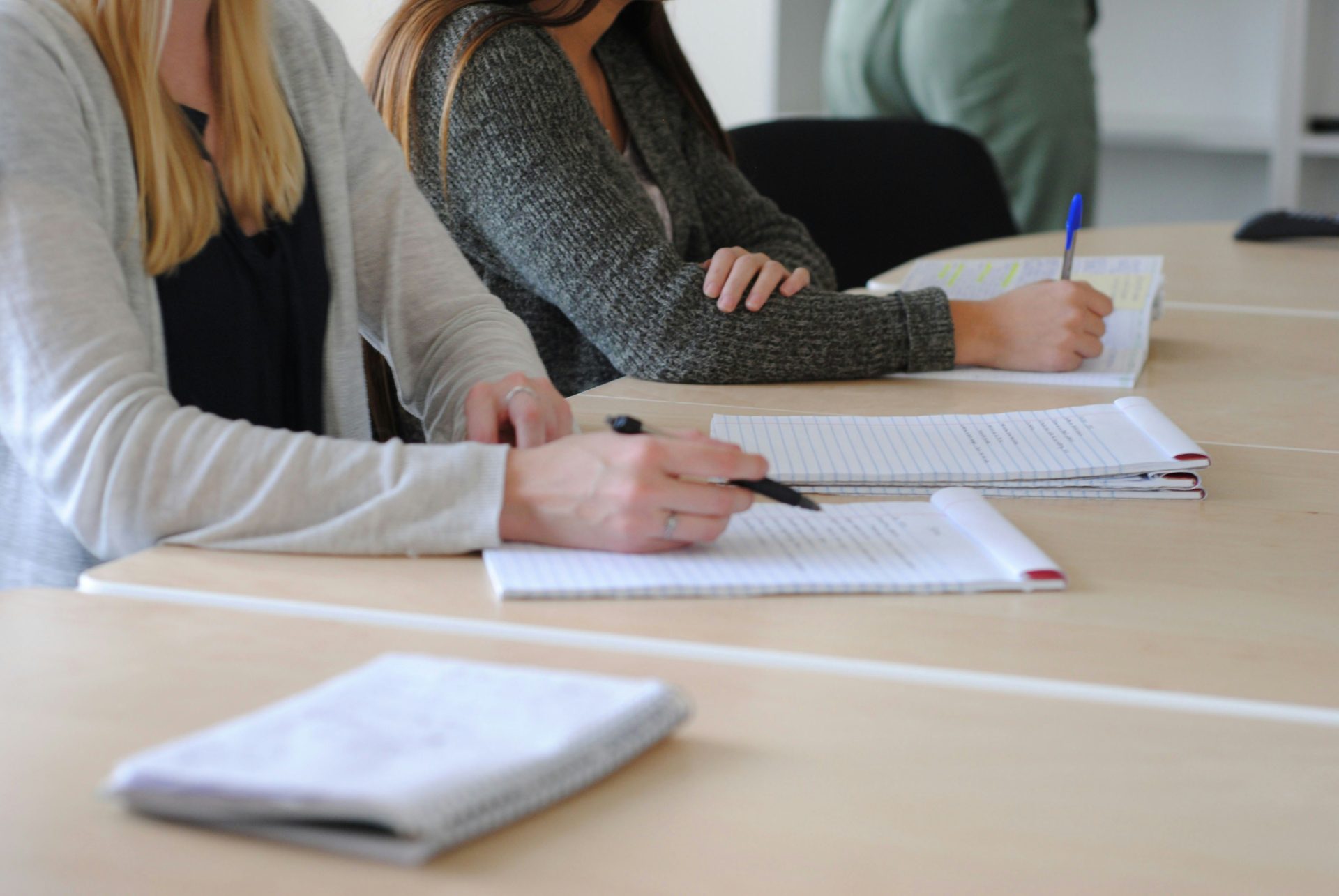 eine Frau, die auf ein Blatt Papier schreibt